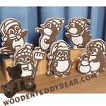 Example of all six finished penguin stand-ups using maple with a walnut overlay on a wooden stand, featuring the brand 'WoodenTeddyBear.com'.